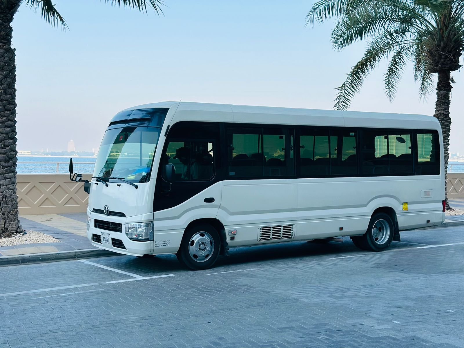 22 Seater coaster minibus in white color side view available in dubai